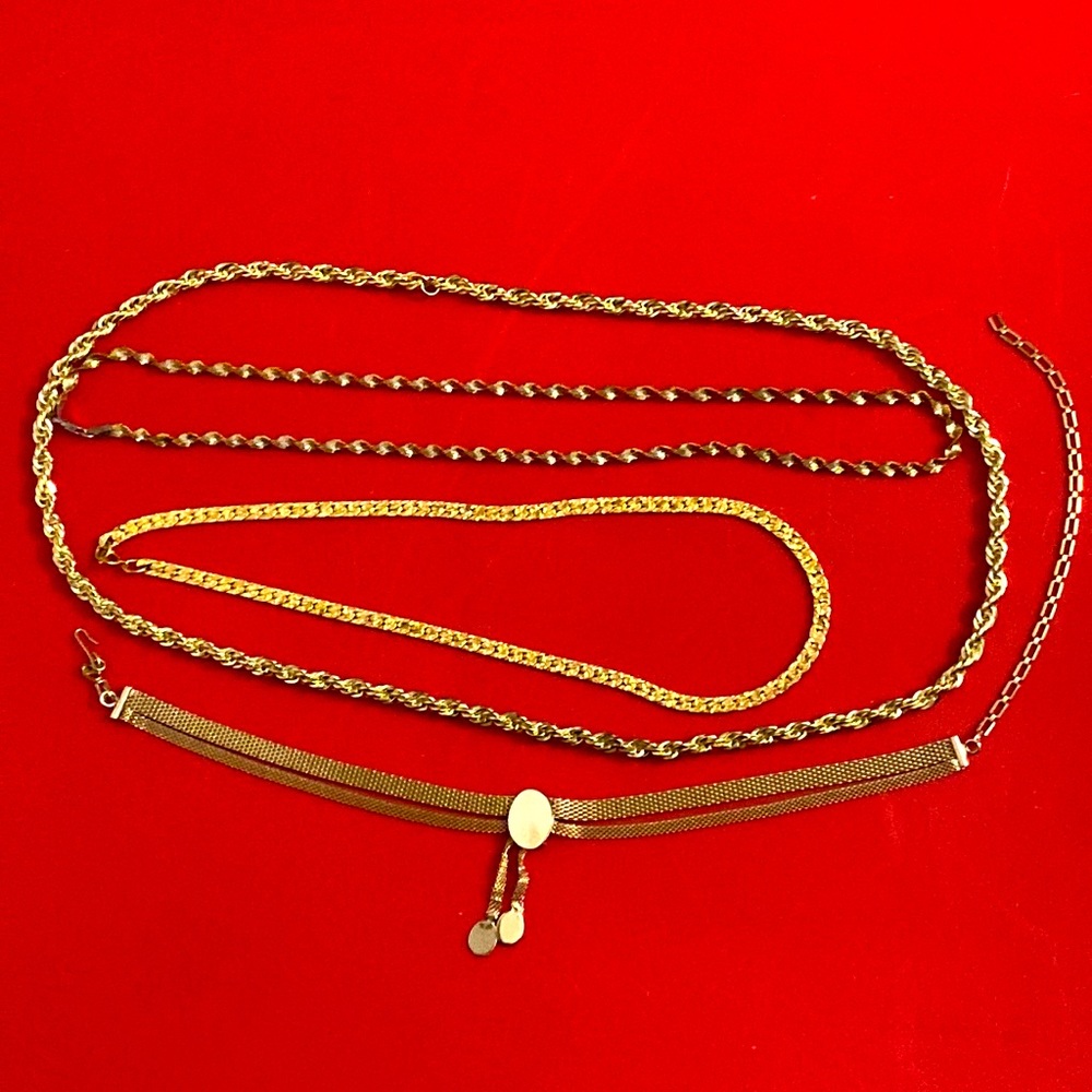 4 gold tone costume necklaces.
